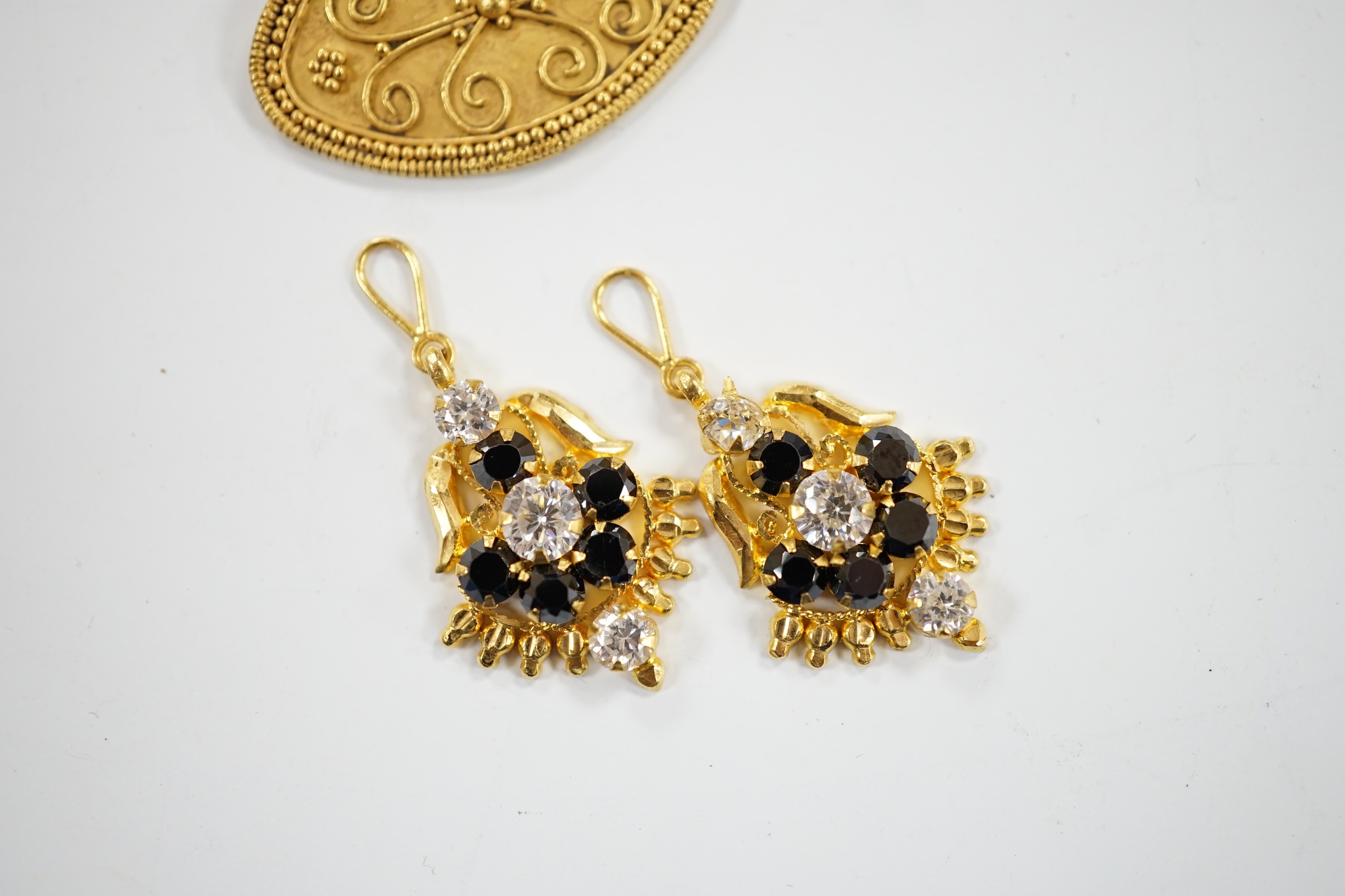A pair of Middle Eastern two colour sapphire? cluster set drop earrings, the fittings stamped 916, together with a Middle Eastern yellow metal oval pendant, 26mm, with wirework decoration, gross weight 6.7 grams.